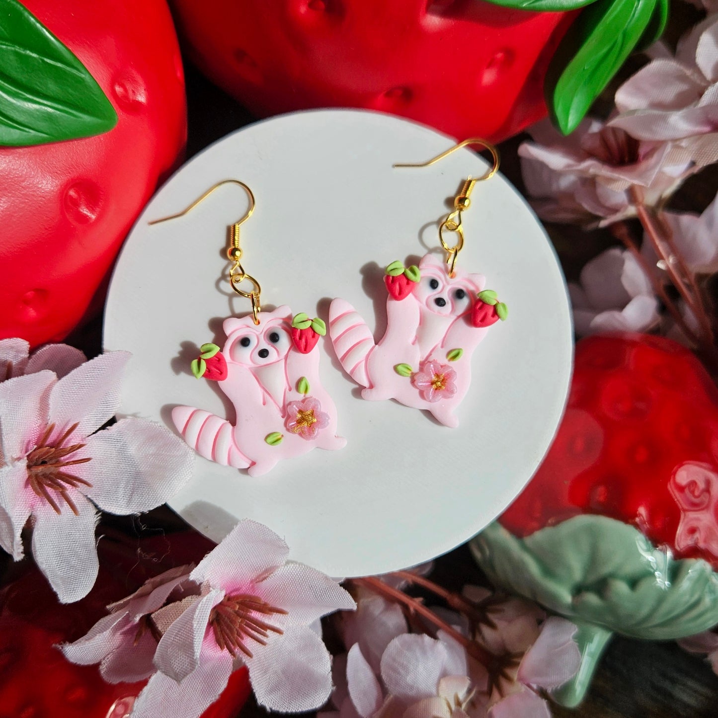 Raccoons holding Strawberry & Sakura